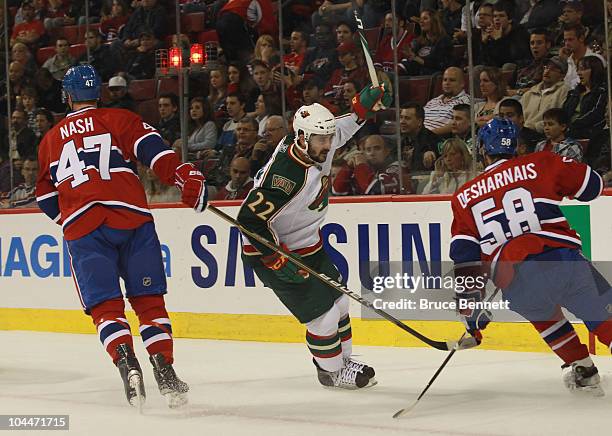 Cal Clutterbuck of the Minnesota Wild scores at 12:12 of the first period against the Montreal Canadiens at the Bell Centre on September 26, 2010 in...