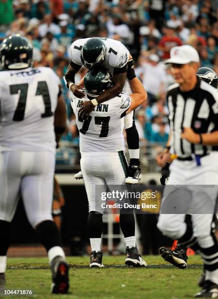 Quarterback Michael Vick of the Philadelphia Eagles is congratulated by offensive lineman Mike McGlynn after throwing a touchdown pass to wide...