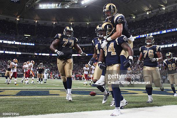 Kenneth Darby of the St. Louis Rams is congratulated by teammate Danny Amendola after scoring a touchdown against the Washington Redskins at the...
