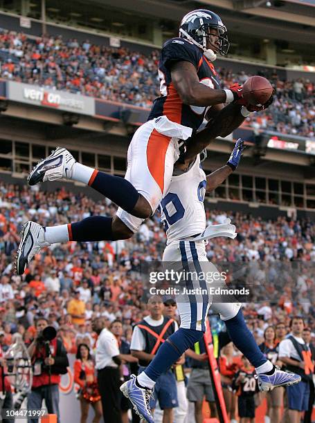 Wide receiver Demaryius Thomas of the Denver Broncos battles in the air with cornerback Kelvin Hayden of the Indianapolis Colts during NFL action at...