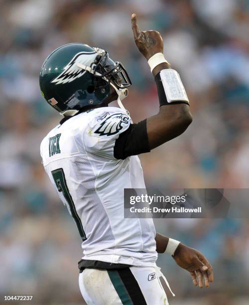 Quarterback Michael Vick of the Philadelphia Eagles points to the sky after a touchdown pass during the game against the Jacksonville Jaguars at...