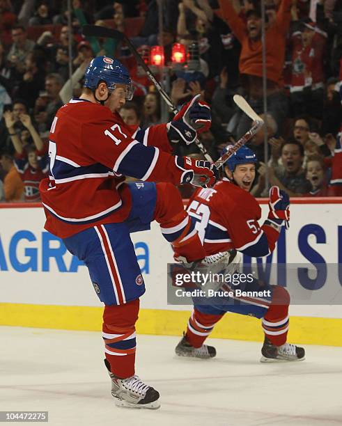 Dustin Boyd of the Montreal Canadiens scores at 6:57 of the second period against the Minnesota Wild while teammate Ryan White celebrates in the...