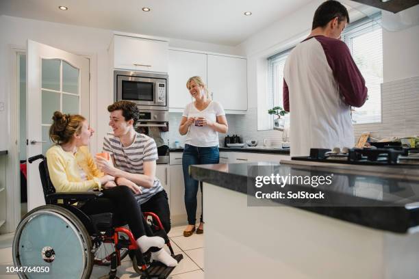 happy family socialising in the kitchen - weakness stock pictures, royalty-free photos & images