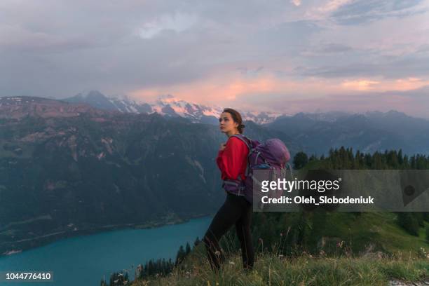 Woman hiking on the mountain ridge in Swiss Alps