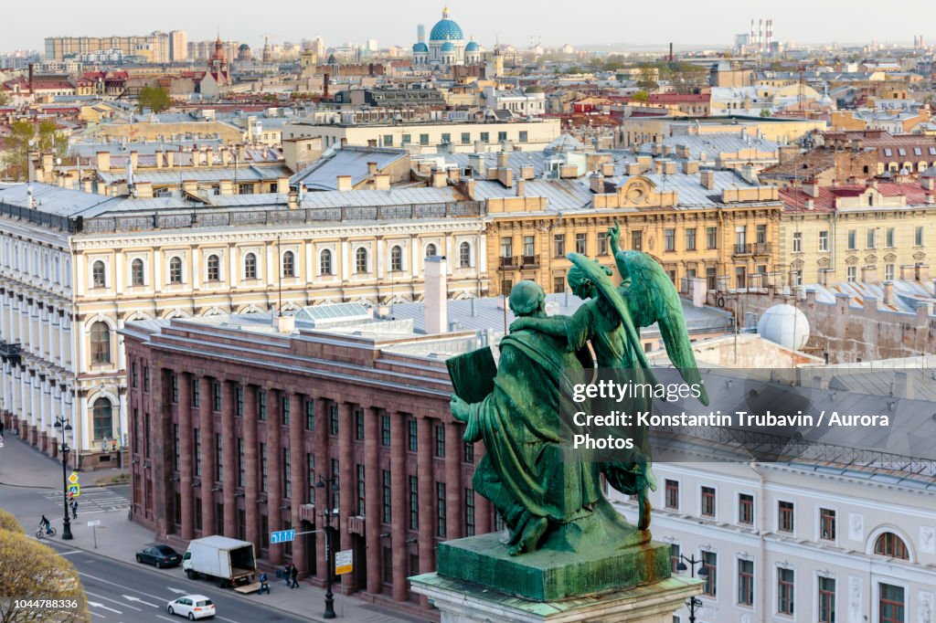 Photograph with aerial view of St. Petersburg and statue from colonnade of St. Isaac Cathedral, Russia