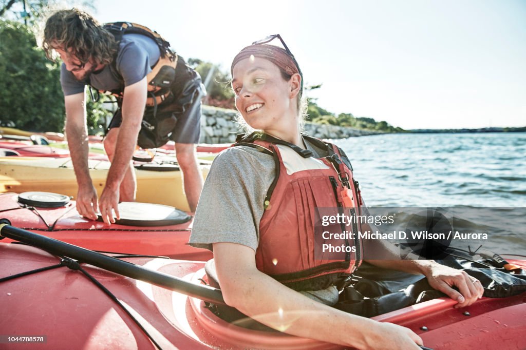 Photograph of young woman looking back at tandem kayak partner, Portland, Maine, USA