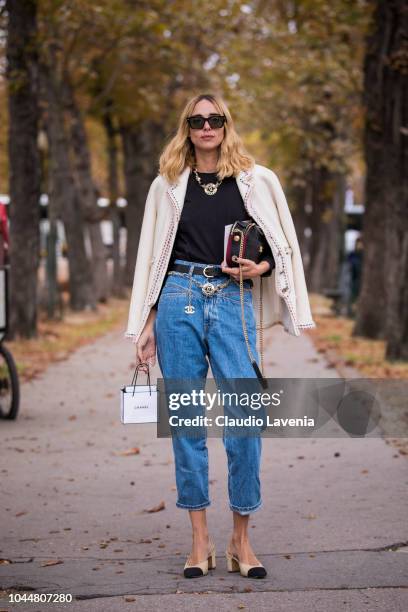 Candela Pelizza, wearing a black top, blue jeans with Chanel belt, Chanel shoes, black Chanel bag and nude jacket, is seen after the Chanel show on...