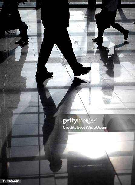 Business people walking on an escalator at the Photokina fair on September 21, 2010 in Cologne, Germany. The Photokina is the world's biggest trade...