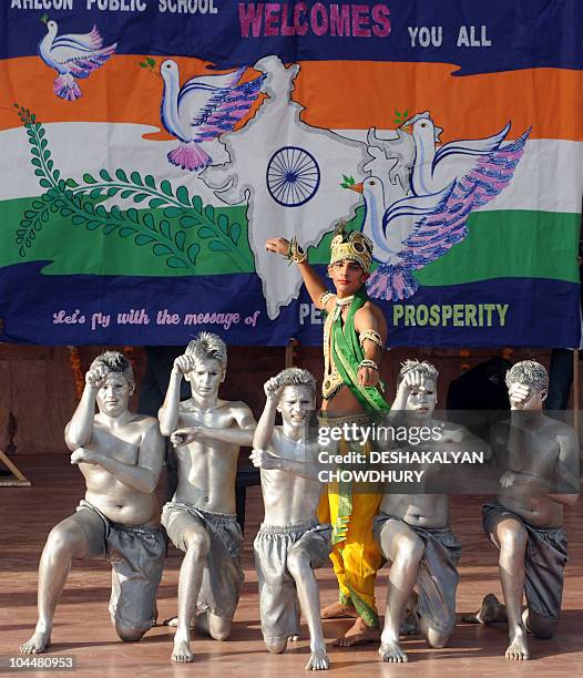 Indian artists perform on stage during the flag hoisting cermony at the Commonwealth Games' village in Delhi on September 27, 2010. The contingent of...