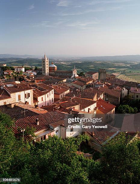 elevated view across rooftops at sunset - massa marittima bildbanksfoton och bilder