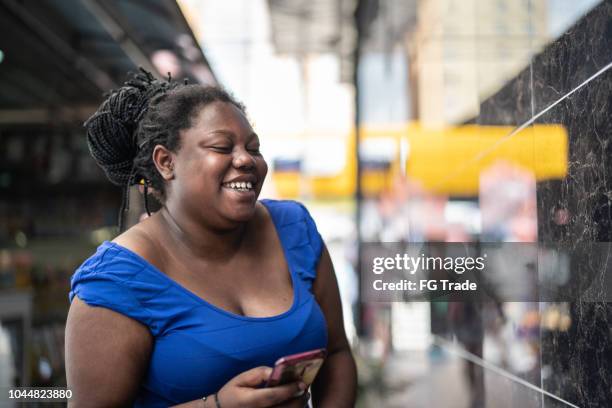 african ethnicity woman using mobile - curvy black woman stock pictures, royalty-free photos & images