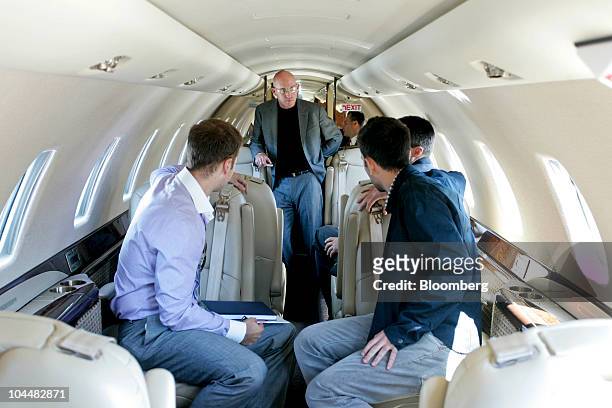 Todd Greene, founder of HeadBlade, center, stands inside a Textron Inc. Cessna Citation Sovereign business jet parked at Santa Monica Municipal...