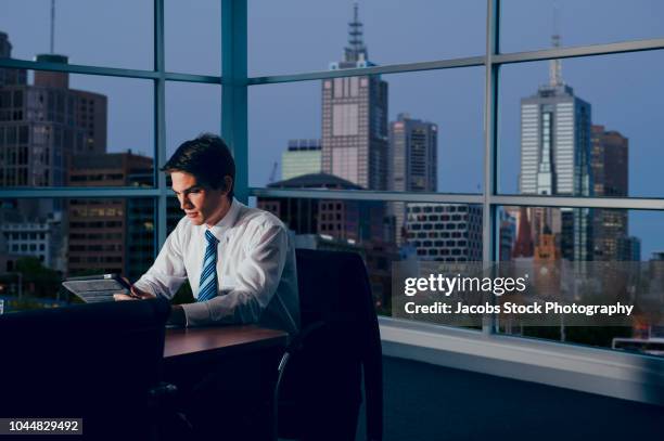 businessman in office at night - white night melbourne stock pictures, royalty-free photos & images