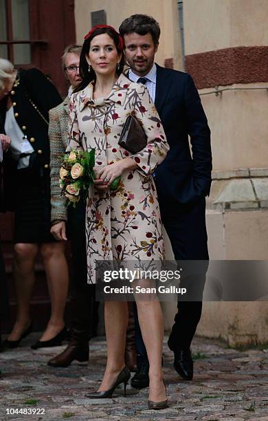 Danish Crown Prince Frederik and Danish Crown Princess Mary, who is pregnant with twins, emerge from the Schwerin State Museum on September 27, 2010...