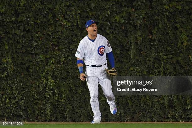 Albert Almora Jr. #5 of the Chicago Cubs celebrates after catching a fly ball at the wall in the second inning against the Colorado Rockies during...