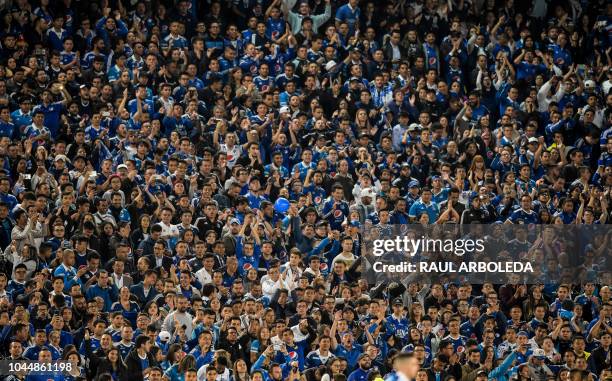 Fans of Colombia's Millonarios cheer during the Copa Sudamericana football match against Colombia's Independiente Santa Fe, at the Nemesio Camacho El...