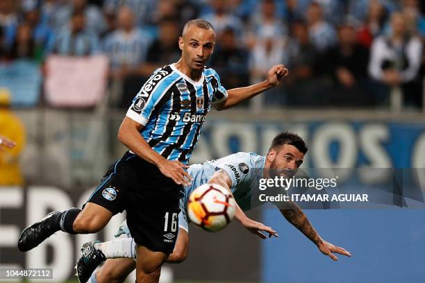 Jose San Roman of Argentina's Atletico Tucuman vies for the ball with Cícero of Brazil's Gremio, during their Copa Libertadores 2018 football match...