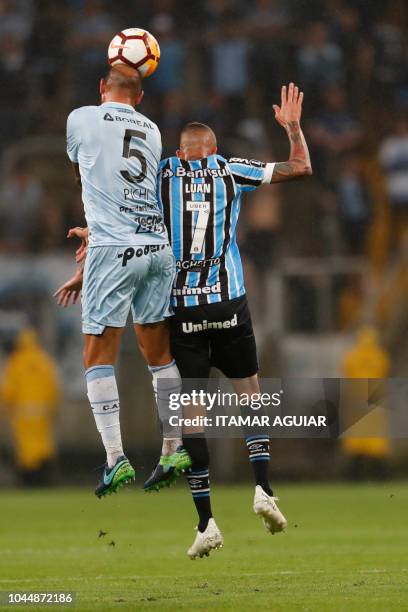 Juan Mercier of Argentina's Atletico Tucuman jumps for a header with Luan of Brazil's Gremio, during their Copa Libertadores football match, at the...