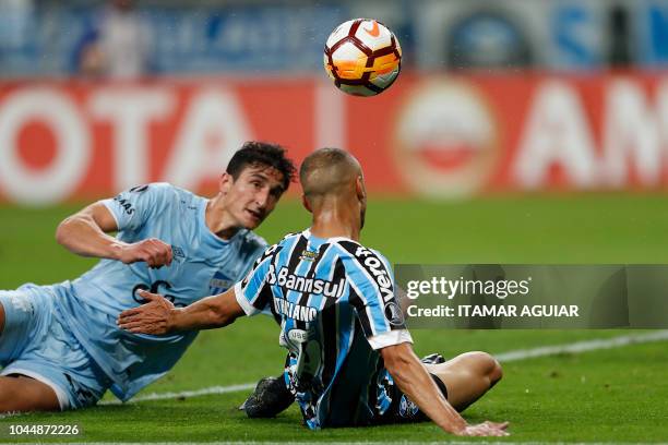 Andres Lamas of Argentina's Atletico Tucuman, vies for the ball with Cicero of Brazil's Gremio, during their Copa Libertadores 2018 football match...