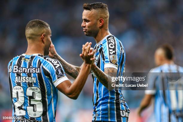 Luan of Gremio celebrates with teammate Alisson after scoring the first goal of his team during the match between Gremio and Atletico Tucuman, part...