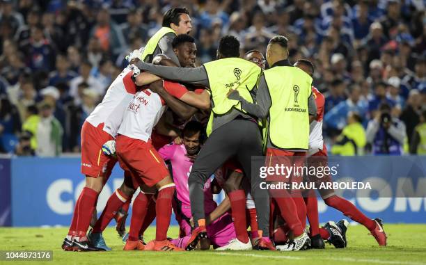 Colombia's Independiente Santa Fe players celebrate at the end of their Copa Sudamericana football match against Colombia's Millonarios at the...