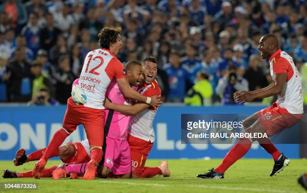 Colombia's Independiente Santa Fe players celebrate at the end of their Copa Sudamericana football match against Colombia's Millonarios at the...
