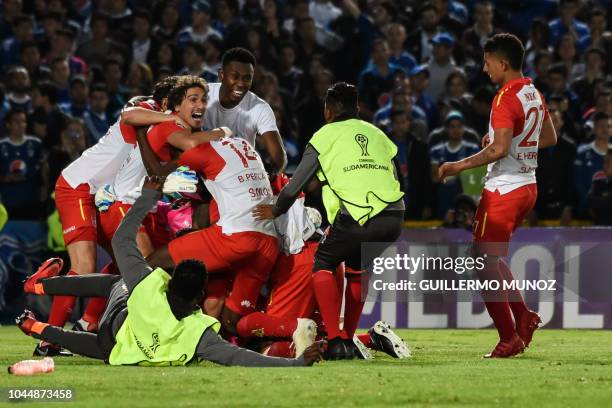 Colombia's Independiente Santa Fe players celebrate at the end of their Copa Sudamericana football match against Colombia's Millonarios at the...