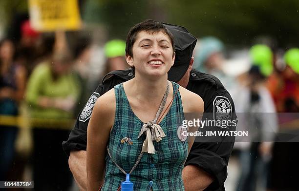 Protester is arrested for staging a sit-in as environmentalists and other protesters rallying outside the White House in Washington, DC, September 27...