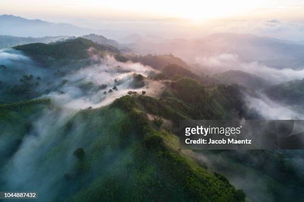 aerial view of mountains with clouds in south cotabato, sarangani, mindanao, philippines. - philippines aerial stock pictures, royalty-free photos & images