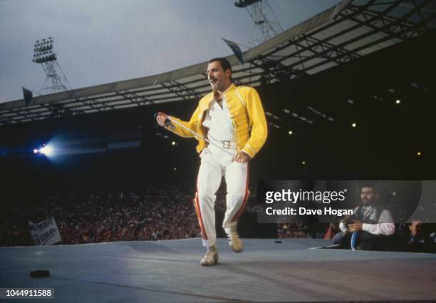 Singer Freddie Mercury performing with Queen at Wembley Stadium, London, July 1986. The band played two nights at the venue, as part of the Magic...