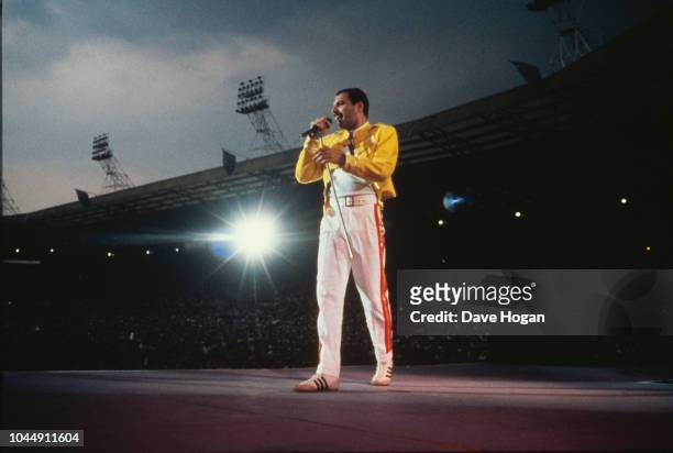 Singer Freddie Mercury performing with Queen at Wembley Stadium, London, July 1986. The band played two nights at the venue, as part of the Magic...