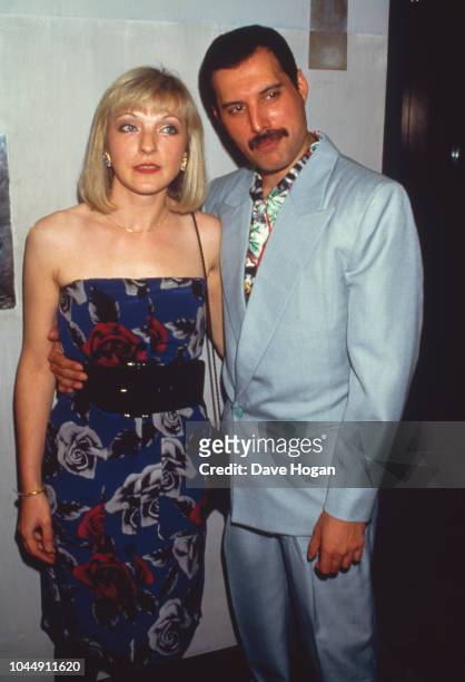 Singer Freddie Mercury with his friend Mary Austin at an after-party for Queen's Wembley concerts, Kensington Roof Gardens, London, 12th July 1986.