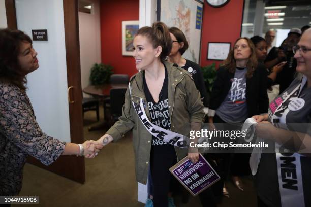 Actor Alyssa Milano greets Angelina Estrada-Burney, administrative services director for Sen. Lisa Murkowski , as a large group of protesters visit...