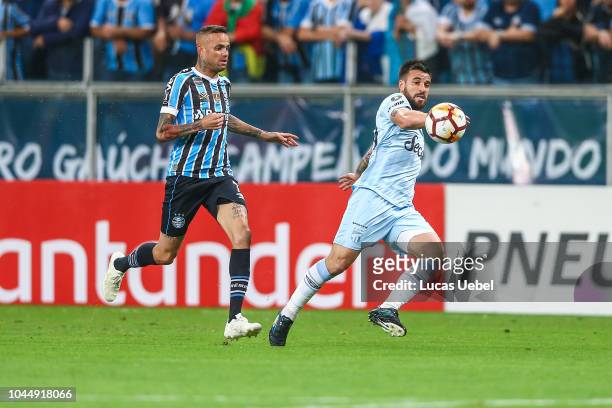 Luan of Gremio battles for the ball against San Roman of Atletico Tucuman during the match between Gremio and Atletico Tucuman, part of Copa Conmebol...