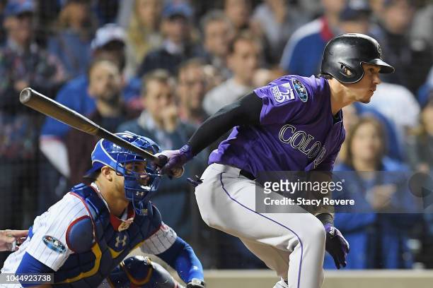 Tony Wolters of the Colorado Rockies hits a RBI single to score Trevor Story in the thirteenth inning against the Chicago Cubs during the National...