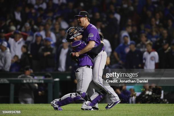 Scott Oberg and Tony Wolters of the Colorado Rockies celebrate defeating the Chicago Cubs 2-1 in thirteen innings to win the National League Wild...