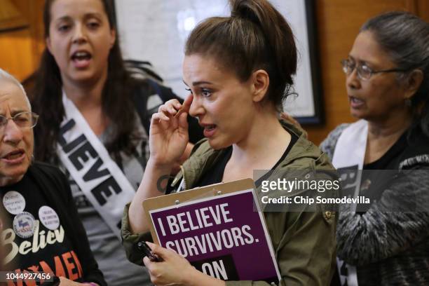 Actress Alyssa Milano and several dozen other protesters listen to sexual assault survivors as they tell their stories the office of Sen. Cindy...