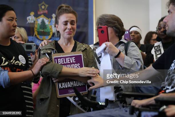 Actress Alyssa Milano is comforted after telling her story of being sexually assaulted while she and dozens of other protesters demonstrate against...