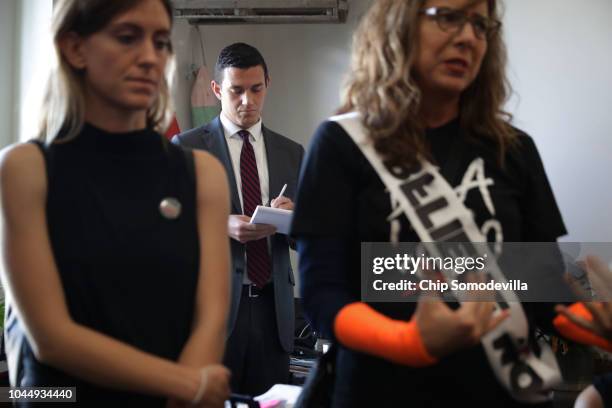 Bryan Allen , staff assistant for Sen. Susan Collins , takes notes as sexual assault survivors tell their stories while demonstrating against the...