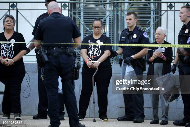 Protesters, many of them sexual assault survivors, are arrested by U.S. Capitol Police for demonstrating against the appointment of Supreme Court...