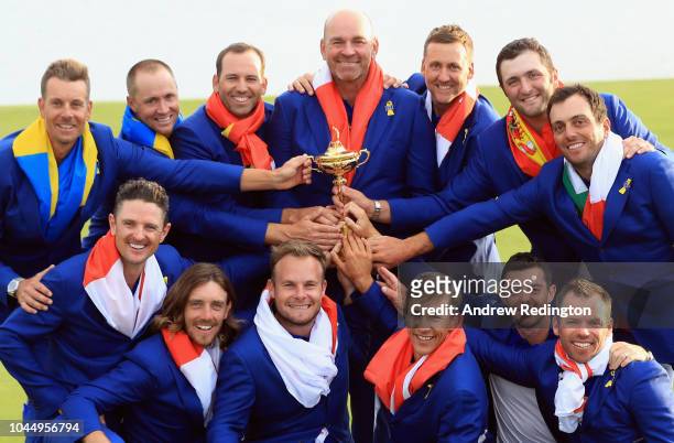 Captain Thomas Bjorn of Europe holds The Ryder Cup trophy as The European Team celebrate victory following the singles matches of the 2018 Ryder Cup...