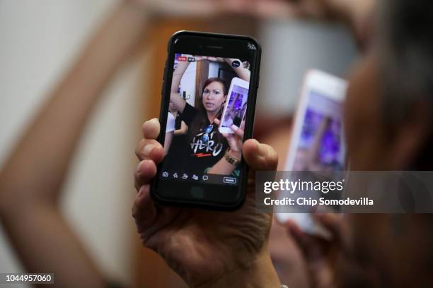 Protesters, many of them sexual assault survivors, use their phones to record and to live broadcast their demonstrations against the appointment of...