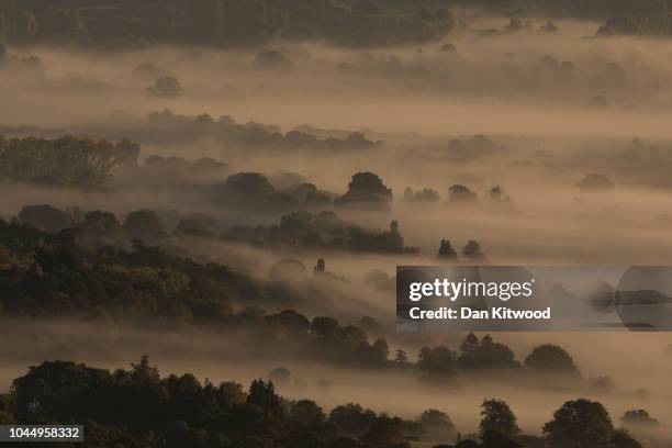 Mist hangs in the Valley near Amberley in the South Downs National Park on October 3, 2018 in Amberly, United Kingdom.
