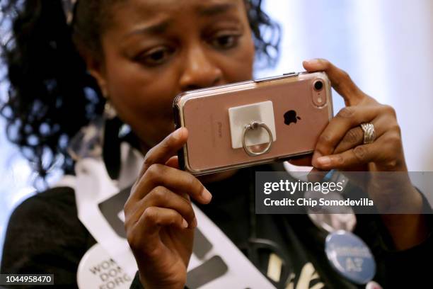 Protesters, many of them sexual assault survivors, use their phones to record and to live broadcast their demonstrations against the appointment of...