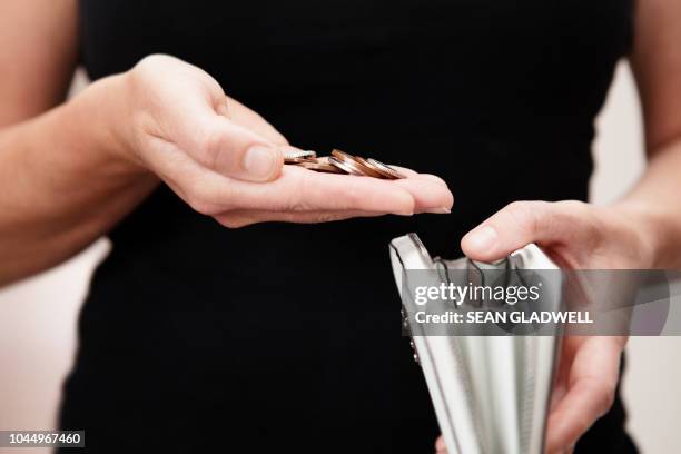 woman with coins in hand with purse - ハンドバッグ ストックフォトと画像