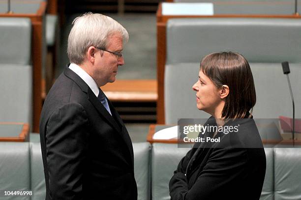 Foreign Minister Kevin Rudd and Health Minister Nicola Roxon wait to be sworn in in the House of Representatives chamber at Parliament House Canberra...