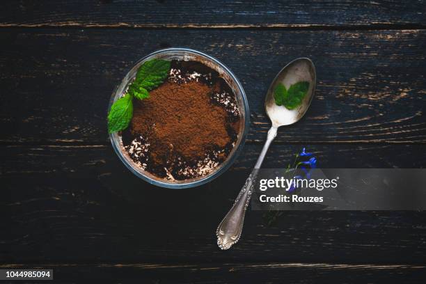 tiramisu with mint in glass on wooden surface - tiramisu stock pictures, royalty-free photos & images