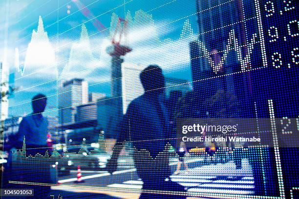 reflection of stock market graph in window - mercato foto e immagini stock