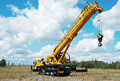 Mobile crane with its boom risen outdoors