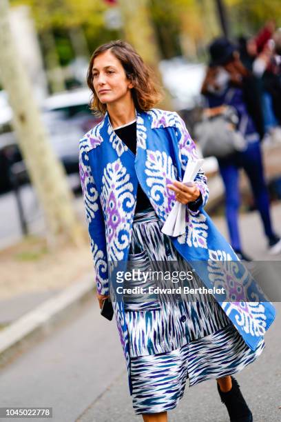 Guest wears a blue Miu Miu jacket, a striped skirt, outside Miu Miu, during Paris Fashion Week Womenswear Spring/Summer 2019 on October 2, 2018 in...